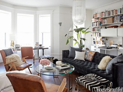 Nate Berkus turns the stark space into an inviting multipurpose room. Creating a focal point and a plush sofa.